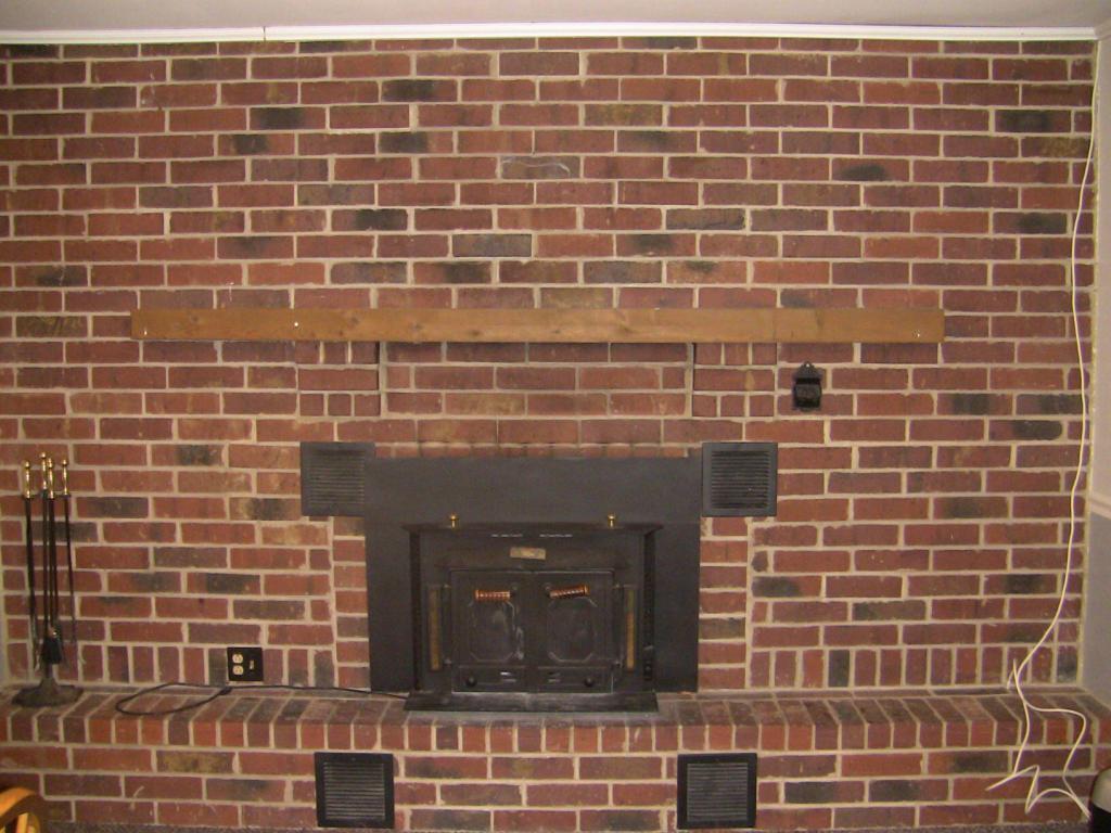 brick fireplace with Buck stove and wood mantel; runs the entire length of the wall