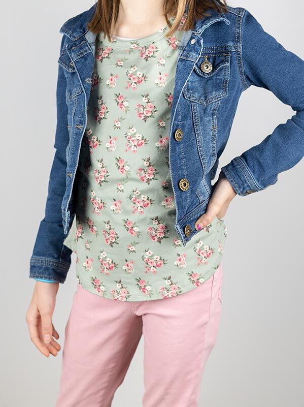 girl modeling pink jeans, floral shirt, and jean jacket